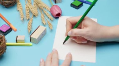 Womens hands sign a holiday card for Easter. Happy easter. High quality 4k footage