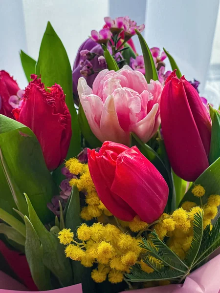 Stock image spring bouquet of pink tulips, mimosa and phlox. Bright bouquet for a gift. High quality photo