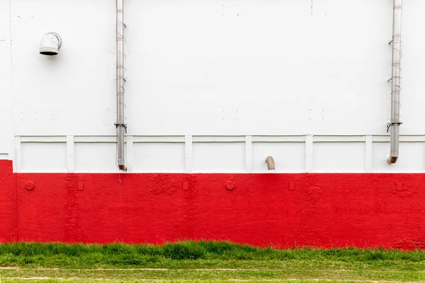 Industrial building with metal pipes and red and white walls. Exterior of the food factory in Brazil