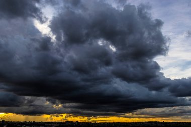 Dark clouds and rainy over the city in Brazil at a sunset