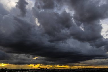 Dark clouds and rainy over the city in Brazil at a sunset