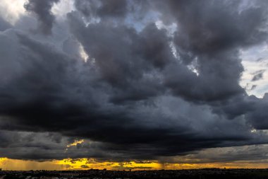Dark clouds and rainy over the city in Brazil at a sunset