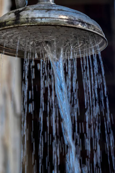 stock image Stone wall with shower with falling water, outdoors in a swimming pool in Brazil