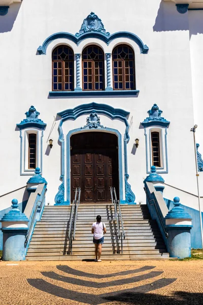 Middle-aged woman in front of the facade of the Cathedral of Sao Bento, in the center of Marilia, west center of the state of Sao Paulo.