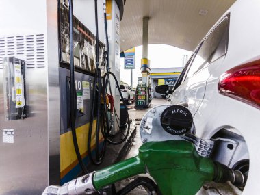 Marilia, Sao Paulo, Brazil, March 08, 2023. Car is fueled with ethanol fuel at a Ipiranga gas station in the city of Marilia, So Paulo state clipart