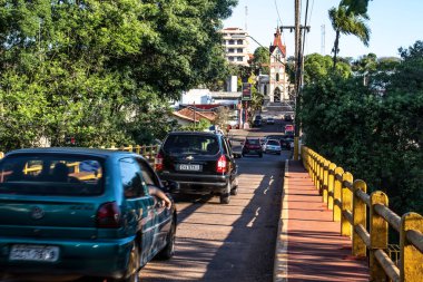 Aguas de Santa Barbara, Sao Paulo, Brezilya, 27 Eylül 2019. Şehrin girişindeki Pardo Nehri üzerindeki köprüde araç trafiği. Arka planda ana kilise var..
