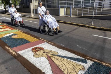 Marilia, SP, Brezilya, 30 Mayıs 2024. Rahibeler, Corpus Christi 'nin kutlaması için dini bir tema ile talaş tozu kükrediğini görürler..