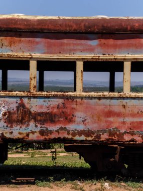 Abandoned, rusty and deteriorated second-class passenger carriage next to the Val de Palmas railway station, also abandoned, in the municipality of Bauru, state of Sao Paulo clipart