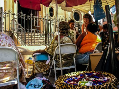 Sao Paulo, Brazil, March 26, 2007. Candombl saint mothers read cowrie shells in front of the Church of the Enforcados in the Liberdade neighborhood, in the central region of the city of Sao Paulo. clipart