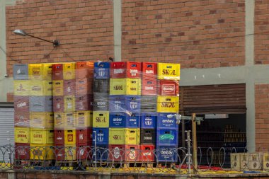 Marilia, Sao Paulo, Brazil, September 03, 2024. Plastic boxes with different brands of beers in the back of a warehouse in the city of Marilia clipart