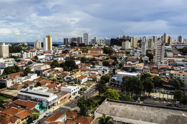 Marilia, SP, Brezilya, 13 Şubat 2025. Marilia şehrinin panoramik manzarası çeşitli mimarileri sergiliyor, modern binalar ve geleneksel evleri bulutlu bir gökyüzü altında birleştiriyor.