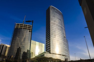Sao Paulo, Brazil, July 28, 2024. Modern skyscrapers in Vila Olimpia, a major business district in Sao Paulo. The contrast of a building under construction next to a finished one in the city growth.
