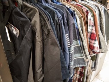 a gingham shirt on a clothes rack in a mall