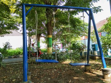 children's swing in a blue garden made of wood