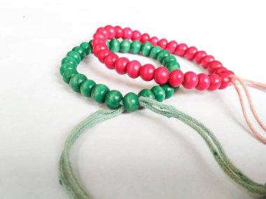 plastic beaded bracelets are round in shape and united by thread