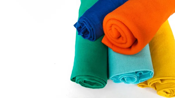 assorted colors of cotton fabric rolls for t-shirts with negative space area on white background
