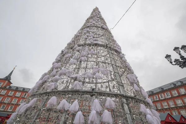 A Christmas Tree in Madrid Spain, in plaza mayor. The tree is made out of Christmas lights in a triangle shape to celebrate the holidays in the city.   The tree is located in the central part of the city.