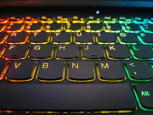 A close up of the buttons on a colorful gaming laptop keyboard