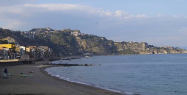 Giardini Naxos beach with Taormina in the background - Sicily, Italy