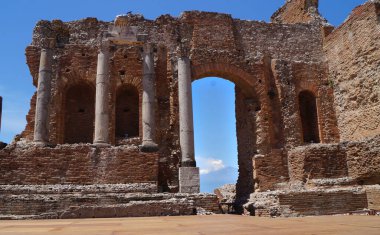 Greek theater with active volcano Etna - Taormina, Sicily, Italy