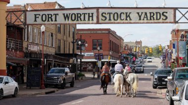 Horseback Riding through the Fort Worth Stockyards in the historic district - FORT WORTH, TEXAS - NOVEMBER 09, 2022 clipart