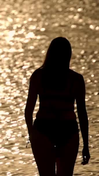 Σιλουέτα Μιας Γυναίκας Ενάντια Στο Χρυσό Νερό Του Ωκεανού Στο — Αρχείο Βίντεο