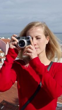 Attractive woman enjoys the view over Alfama - the historic district of Lisbon - travel photography
