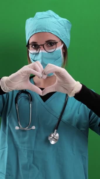 Female Doctor Forms Shape Heart Studio Photography Vertical Video — Stock Video