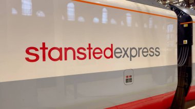 Stansted Express train arriving at London Liverpool Street - LONDON, UNITED KINGDOM - JUNE 9, 2022 clipart