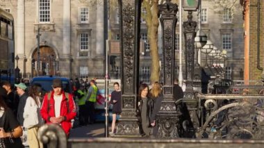 People walking through the beautiful city of Dublin - CITY OF DUBLIN, IRELAND - APRIL 20, 2022