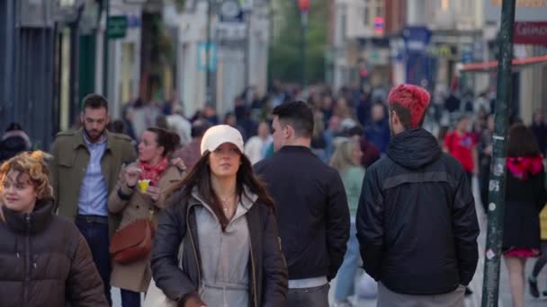 忙しい歩行者ゾーンを歩く大勢の人々 スローモーションでグラフトン通りダブリン アイルランドのダブリン市 エイプリル20 2022 — ストック動画