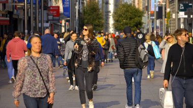 People walking through a busy pedestrian zone - Grafton Street Dublin in slow motion - CITY OF DUBLIN, IRELAND - APRIL 20, 2022