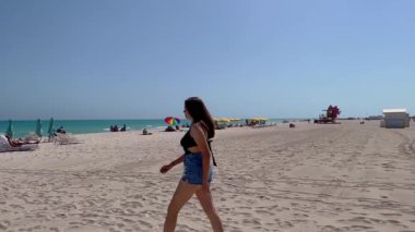 Walking on the sandy beach of Miami North Beach - MIAMI, FLORIDA - FEBRUARY 20, 2022