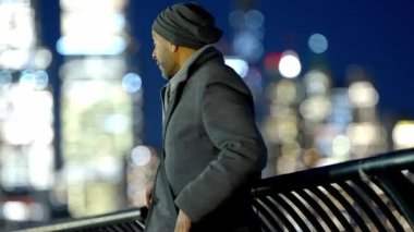Man standing at the waterfront with Manhattan skyline - travel photography