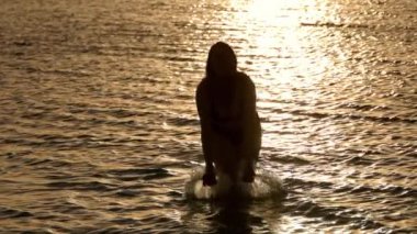 Okyanus suyunun tadını çıkaran bir kadının silueti - arka plan çekimi - Miami Florida seyahat fotoğrafçılığı 