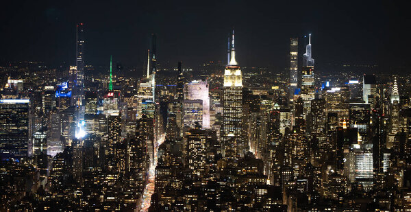 Aerial view over Manhattan with Empire State building by night - NEW YORK, UNITED STATES - FEBRUARY 14, 2023