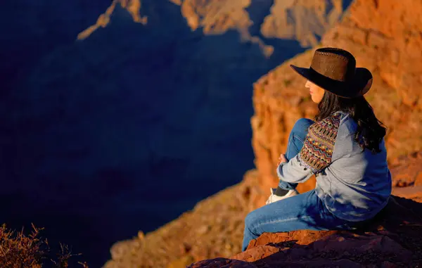 Young woman enjoying the incredibly impressive view over the majestic Grand Canyon - travel photography