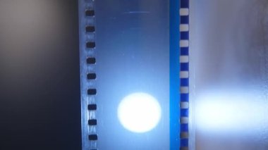 Bir sinemada 35 mm 'lik film şeridi. Bir filmin yakın çekim sahneleri.