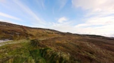 İnanılmaz İrlanda - Arranmore Adası 'ndaki İrlanda batı kıyısında alçak FPV Uçuşu - Bulutlu bir gökyüzünün altında kayalık kıyı şeridinin nefes kesici ve büyüleyici görüntüsü