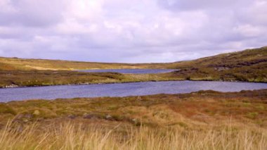 Donegal Irelandanda 'daki Arranmore Adası kırlara kurulmuş huzurlu göller, büyüleyici gökyüzünün altında zarif tepelerle çevrili
