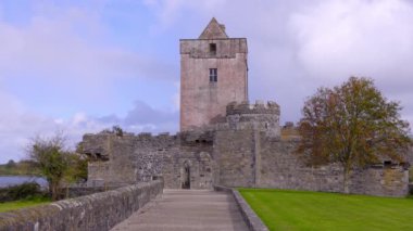 Donegal İrlanda 'daki Doe Kalesi, yemyeşil manzaraların arasına güzel bir şekilde yerleştirilmiş tarihi bir kale kulesinin nefes kesici ve resimli görüntüsü.