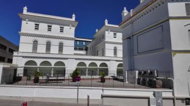 İspanya 'daki Cadiz Körfezi' nin sakin sularına bakan, açık mavi gökyüzünün altında sokak lambaları ve parmaklıklarla huzurlu bir gezinti.