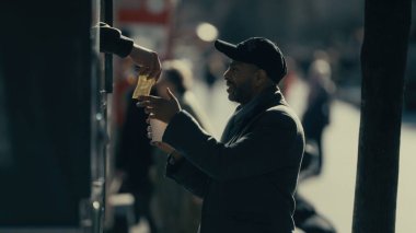 Evsiz adam Manhattan, New York 'ta para bağışında bulunuyor.