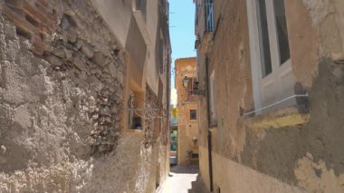 Tropea, Calabria, Güney İtalya 'da yıkık dökük binalar ve sokak lambalarıyla dolu eski bir kasaba dar sokağı.