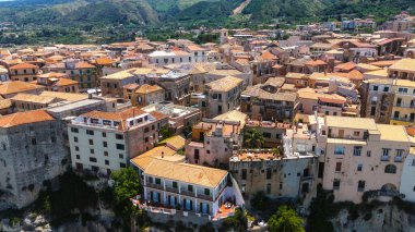 Tropea 'nın manzarasına hükmeden terasotta çatıları olan kümelenmiş evler, Güney İtalya' nın Calabria kentindeki Tyrhenian Denizi 'ne bakan bir uçuruma tünemiş büyüleyici bir kasaba.