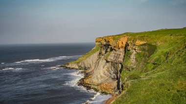 Kuzey Denizi 'yle Whitby' de buluşan görkemli uçurumların nefes kesici manzarası. Kuzey York Moors Ulusal Parkı 'nda büyüleyici bir sahil manzarası.