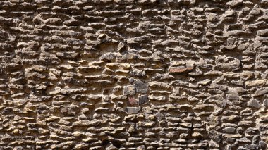 Eski bir ortaçağ taş duvarının kusursuz dokusu, arka plan ve fotoğraf düzenleme için mükemmel.