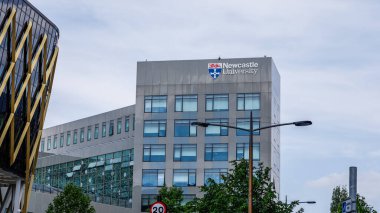 NEWCASTLE, İngiltere - 13 Haziran 2025 - Newcastle Üniversitesi 'nin modern binası Tyne, İngiltere üzerine yükseliyor, logosu açıkça görülüyor