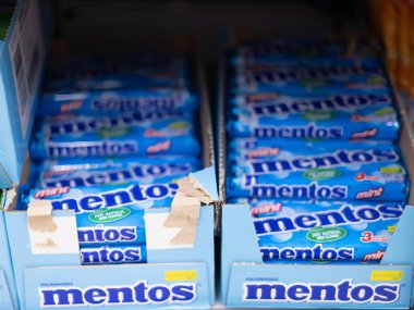 Market raflarında düzenlenmiş canlı bir dizi Mentos şekeri, şeker severlerin tazelik arzusunu tatmin etmeye hazır. - FRANKFURT, Almanya - 21 Mart 2025