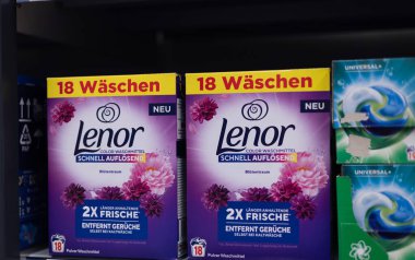 Ekrandaki parlak renkli Lenor deterjan kutuları, bir mağazadaki çamaşır ürünleri için çeşitli kokular ve yıkama becerileri gösteriyor. - FRANKFURT, Almanya - 21 Mart 2025